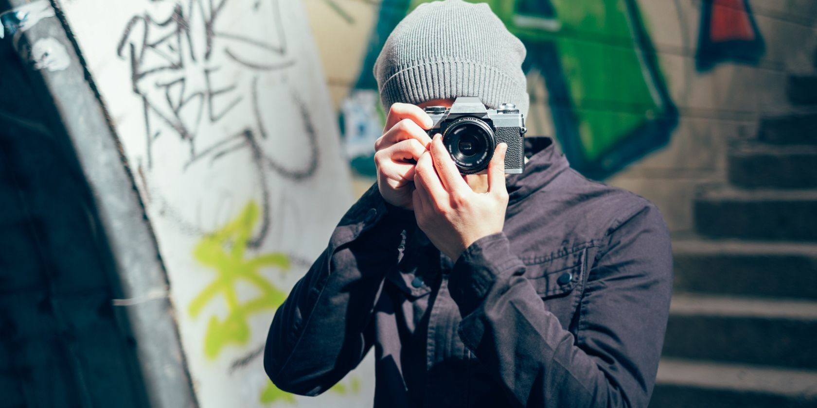 A person looking through a camera lens taking a photo of the photographer