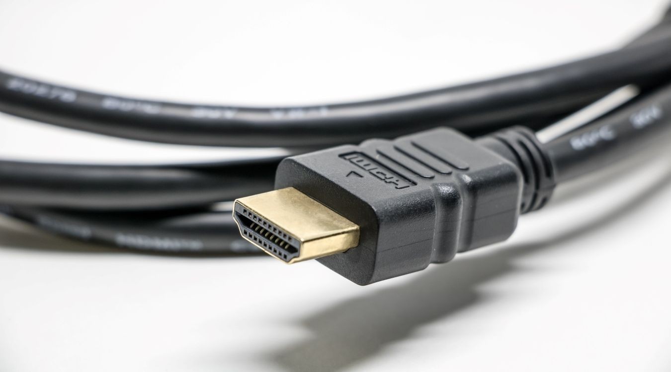 A photograph of a standard HDMI cable atop a white surface