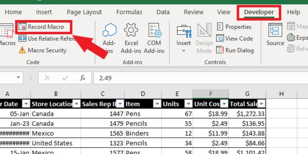Ảnh chụp màn hình thanh công cụ Excel, tab Developer được chọn với mũi tên đỏ chỉ vào tùy chọn Ghi Macro ở bên trái