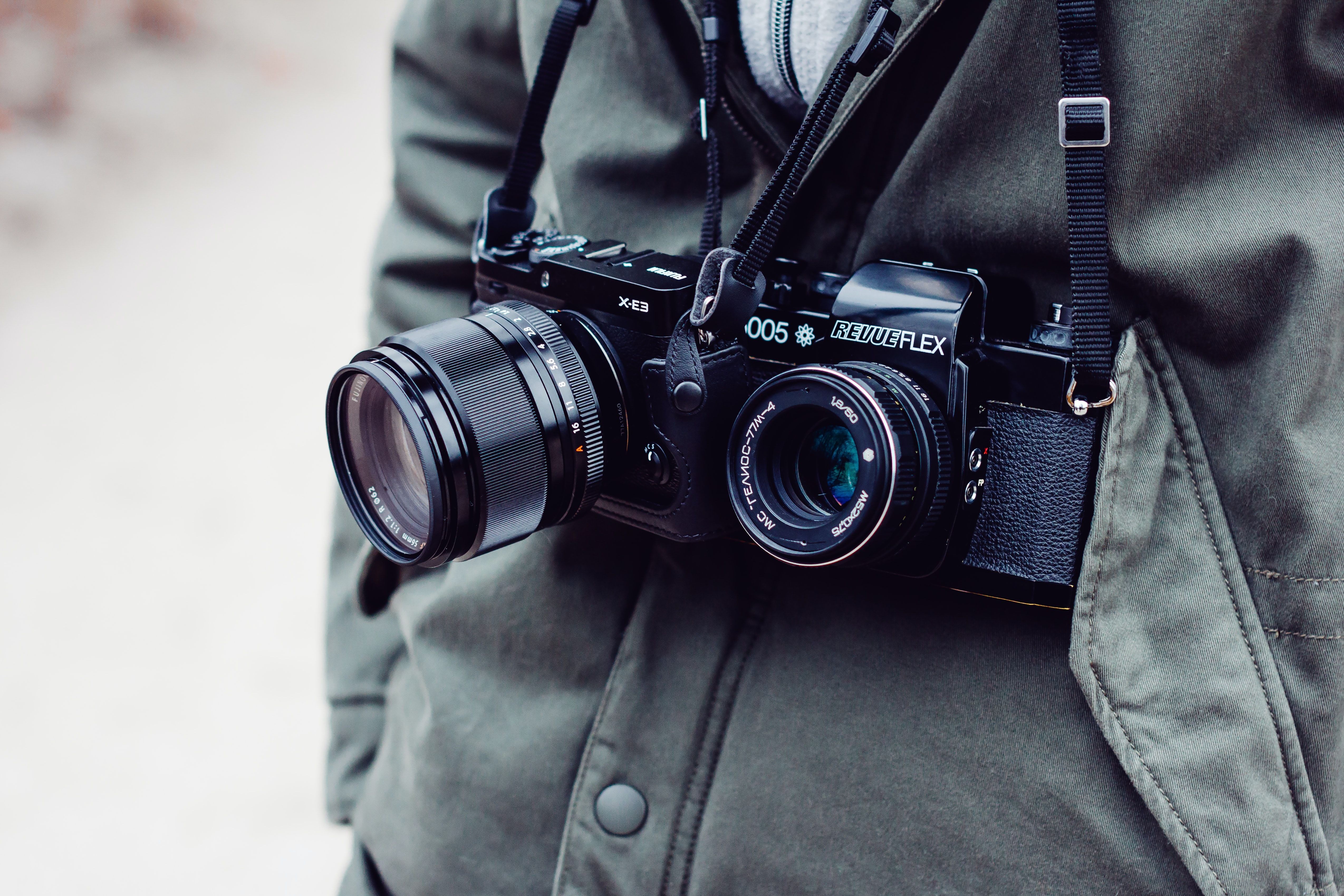 Close up of photographer with two cameras around their neck