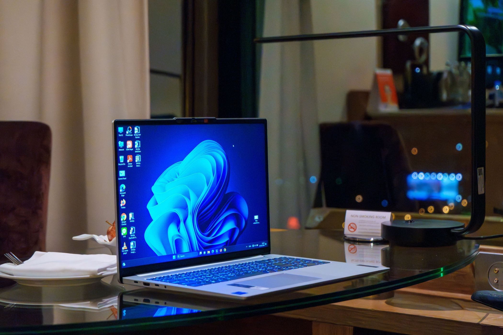 Máy tính Windows trên bàn kính với các biểu tượng trên màn hình