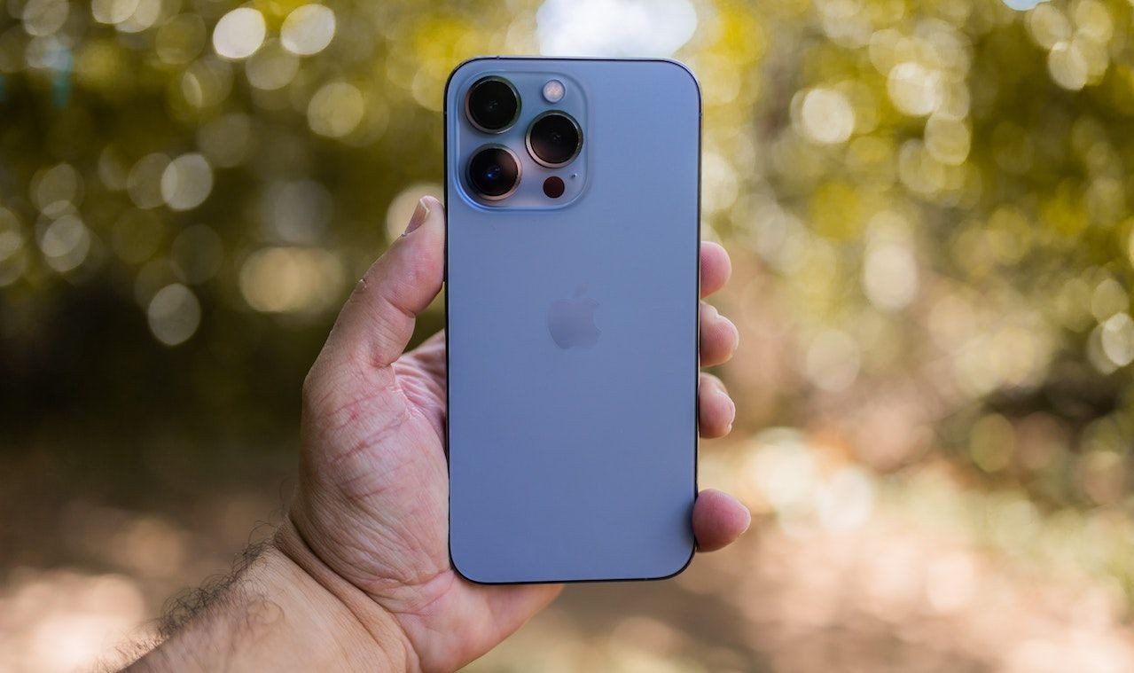 Photo of Person Holding an iPhone 13