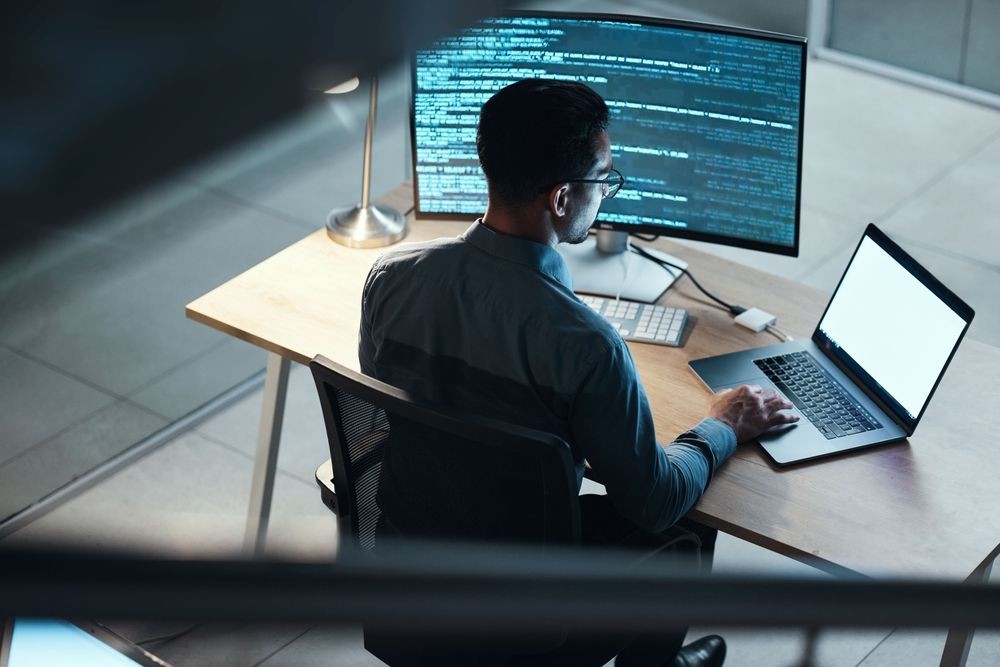 Progammer coding on a laptop