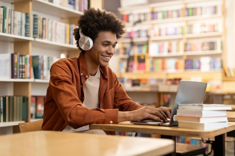 Smiling student using laptop