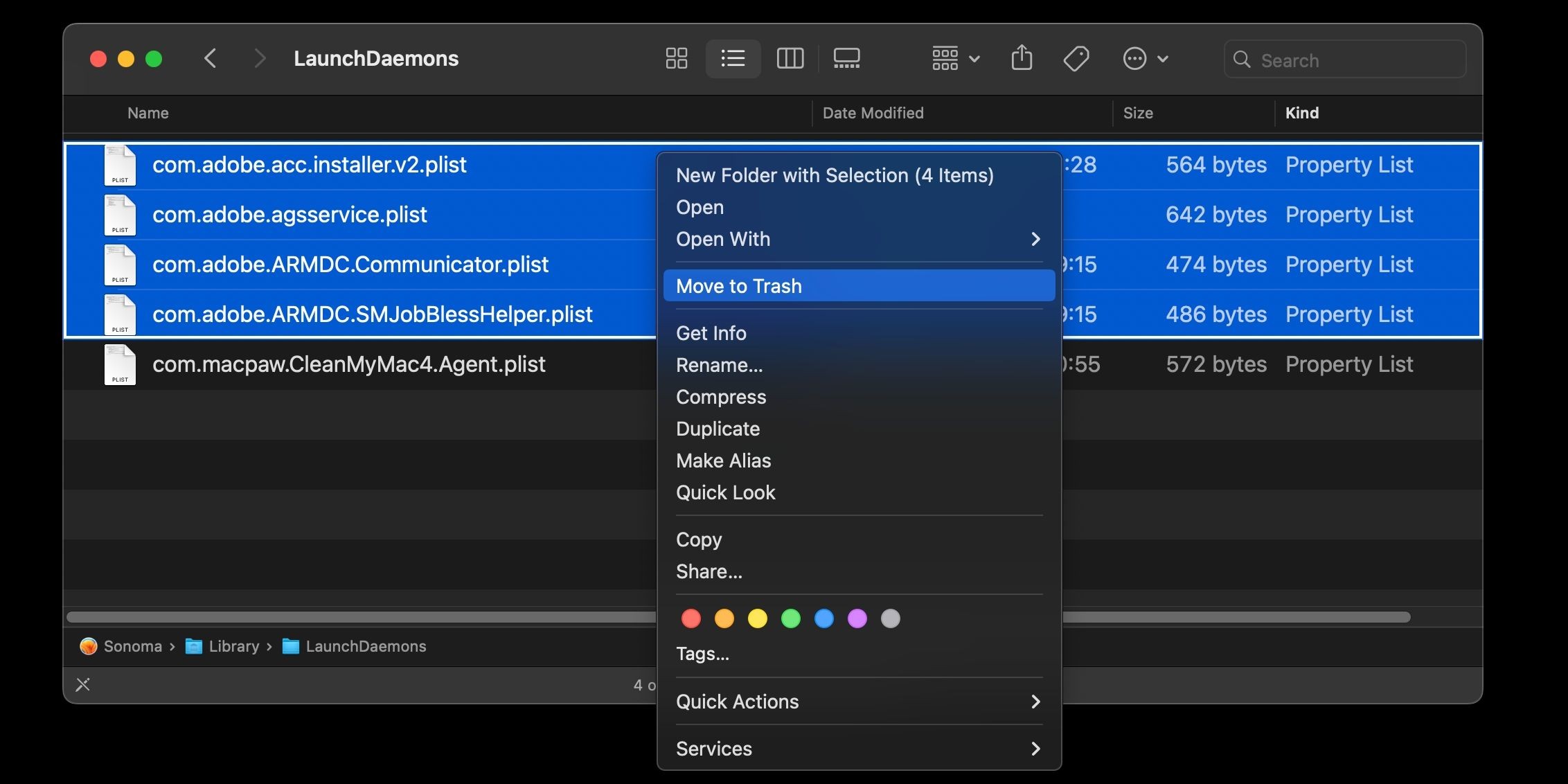 Thư mục LaunchDaemons trong Finder macOS với các tệp danh sách thuộc tính liên quan đến Adobe được chọn