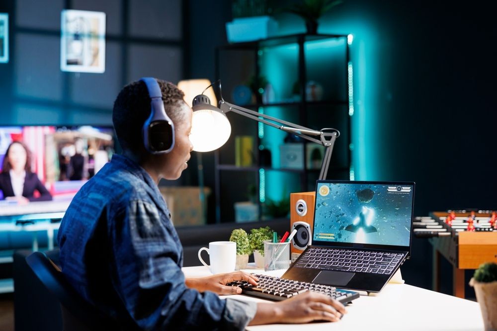 Woman playing a video game on her laptop